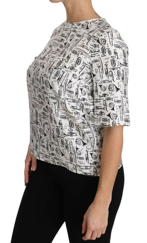 White blouse with musical instruments print by Dolce & Gabbana, featuring long sleeves and a stylish, elegant design.