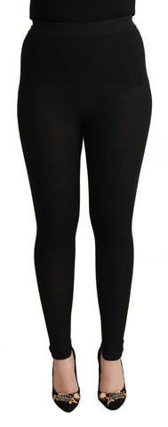 Black cashmere stretch waist tights pants by Dolce & Gabbana, showing close-up of smooth fabric and fitted waist detail.