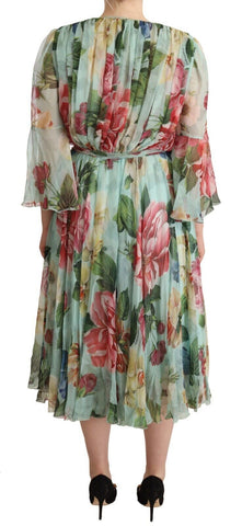 Green floral long sleeve V-neck midi dress by Dolce & Gabbana, featuring a fitted waist and elegant design.