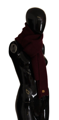 Dark red Dolce & Gabbana cashmere wrap shawl with logo knit pattern, draped over a neutral background, showcasing soft luxury and craftsmanship.