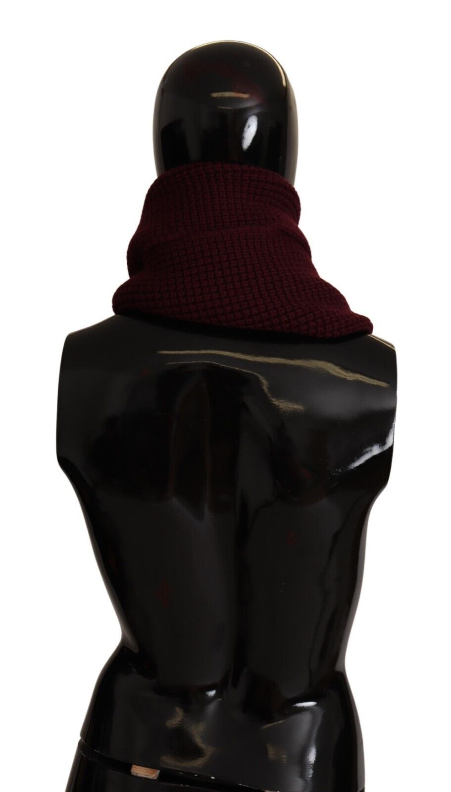 Dark red Dolce & Gabbana cashmere logo wrap shawl with knitted texture, draped to showcase its soft, luxurious fabric.