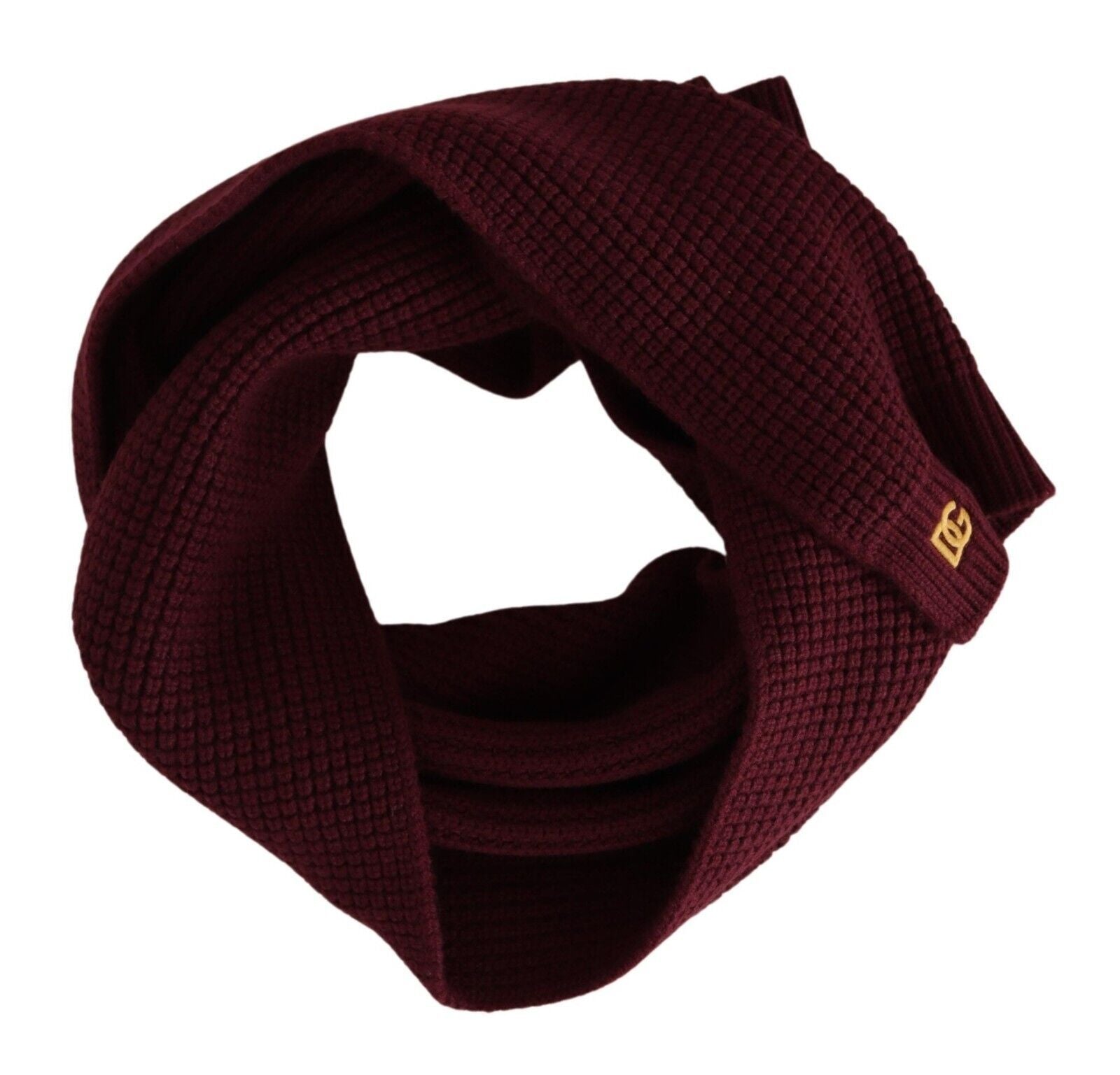 Dark red cashmere wrap shawl with Dolce & Gabbana logo, knitted scarf draped over a neutral background.
