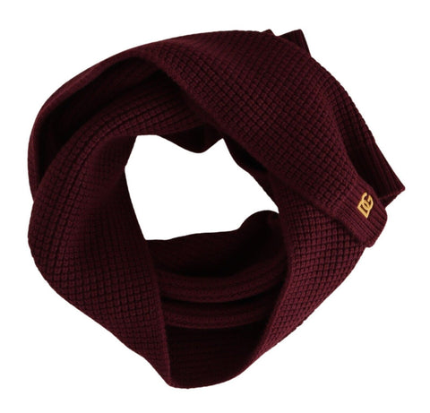 Dark red cashmere wrap shawl with Dolce & Gabbana logo, knitted scarf draped over a neutral background.