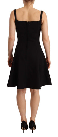 Black fit flare wool stretch sheath dress by Dolce & Gabbana, shown on a hanger with close-up fabric details.