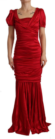 Red silk stretch mermaid gown by Dolce & Gabbana, form-fitting sheath dress with elegant mermaid silhouette and smooth fabric.