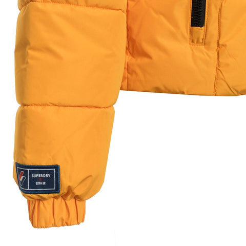 Jag Couture London-New York Superdry jacket, stylish outerwear with logo details, displayed on a hanger in a retail setting.