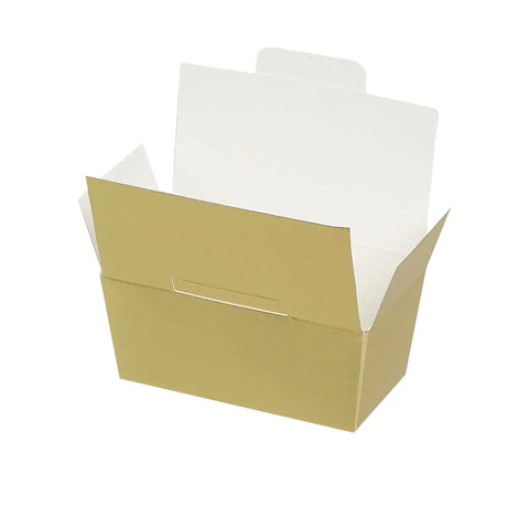 Two matte gold chocolate ballotins from Jag Couture London New York, elegant packaging for gifting or special occasions.