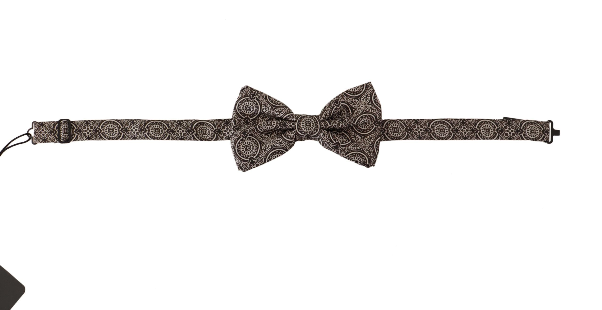Black and white 100% silk adjustable neck papillon tie by Dolce & Gabbana, shown draped on a flat surface.