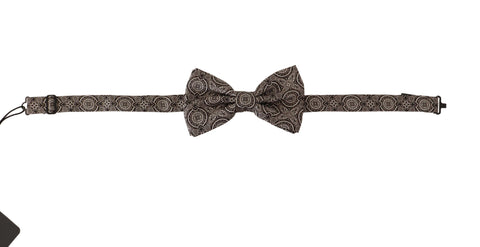 Black and white 100% silk adjustable neck papillon tie by Dolce & Gabbana, shown draped on a flat surface.