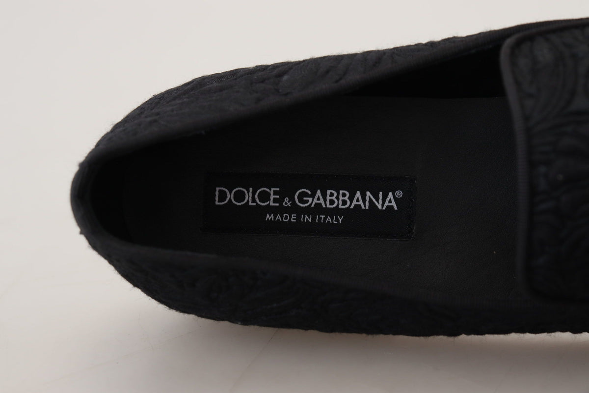 Black floral jacquard loafers by Dolce & Gabbana with slip-on design and intricate floral pattern on textured fabric.