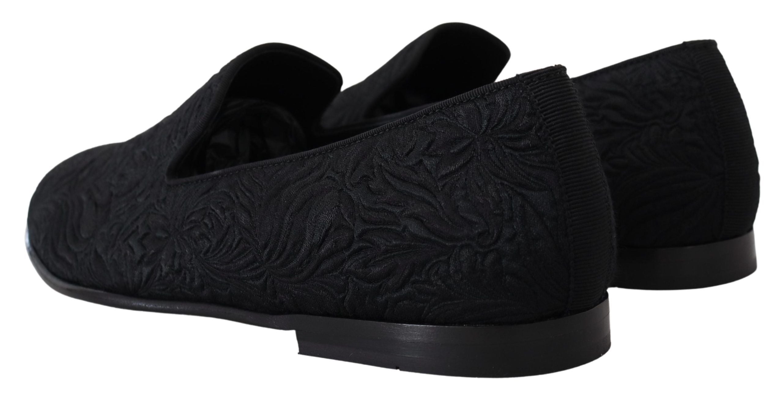 Black floral jacquard slippers with loafer style from Dolce & Gabbana, featuring intricate floral patterns and a sleek, stylish design.