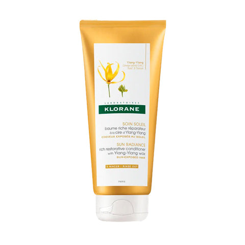 Klorane Enriched Repair Balm with Ylang-Ylang Wax in a 100ml jar, featuring a natural, creamy texture with floral and botanical elements.