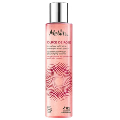 Bottle of Melvita Extraordinary Rose Water Bio 150ml with rose petals and clear liquid inside, placed on a neutral background.