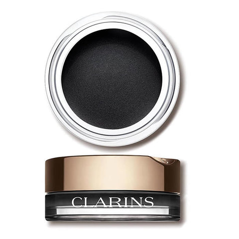 Close-up of Clarins Ombre Velvet 06 Women In Black eyeshadow palette with black and gray shades, displayed on a neutral background.