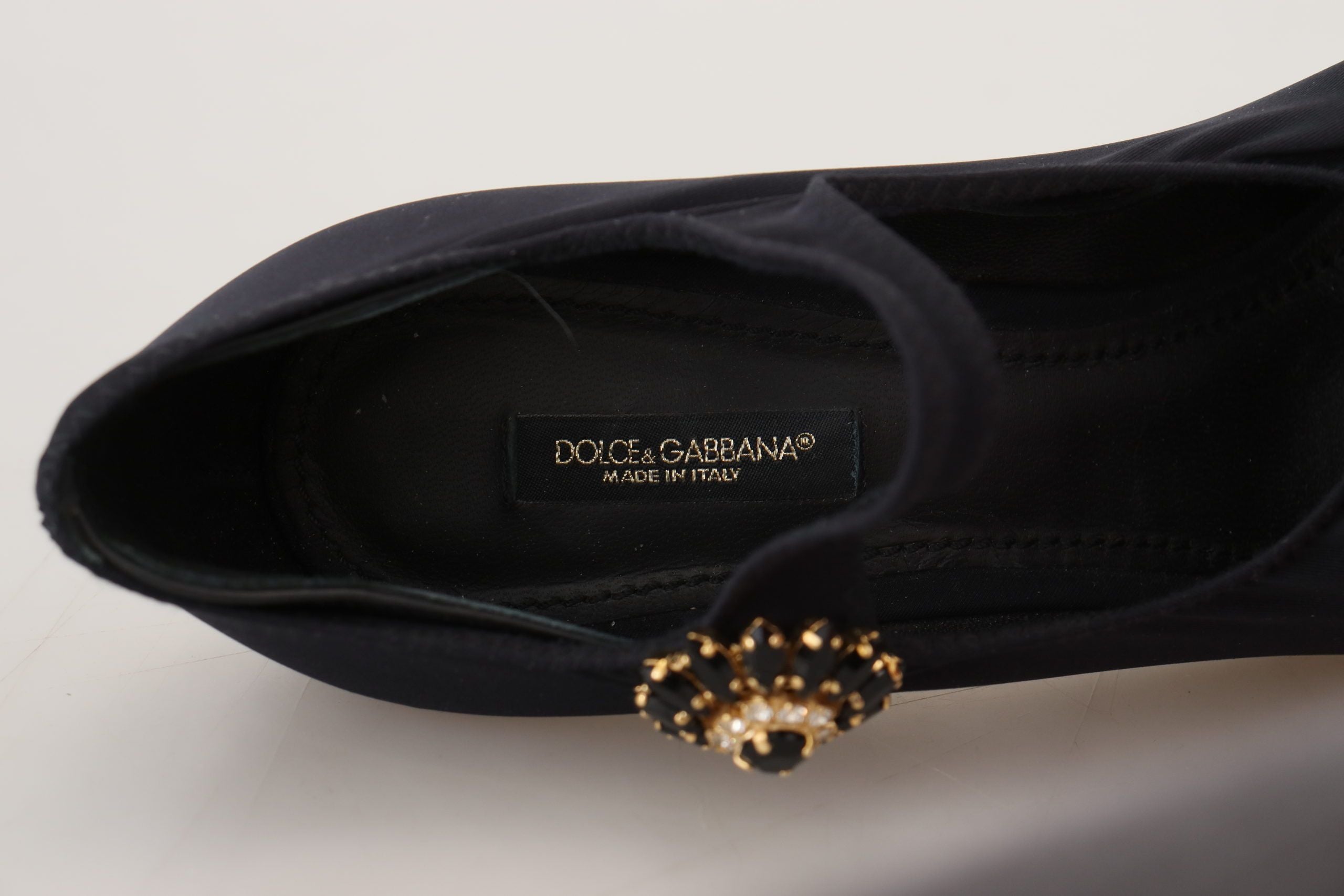 Black stretch crystal pumps featuring sleek design and elegant detailing, perfect for stylish occasions.