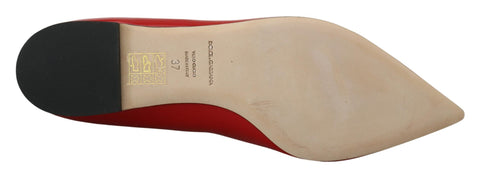 Red leather Dolce & Gabbana loafers with crystal embellishments, featuring a classic flat shoe design.