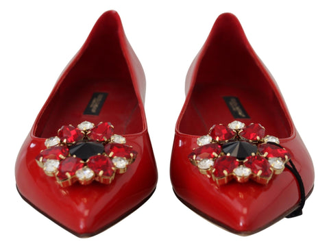 Red leather loafers with crystal embellishments from Dolce & Gabbana, featuring a sleek flat shoe design and stylish detailing.