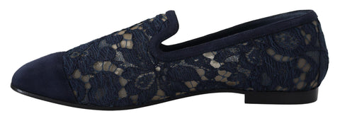 Blue floral lace slip-on loafers from Dolce & Gabbana with intricate lace detailing and a sleek flat shoe design.