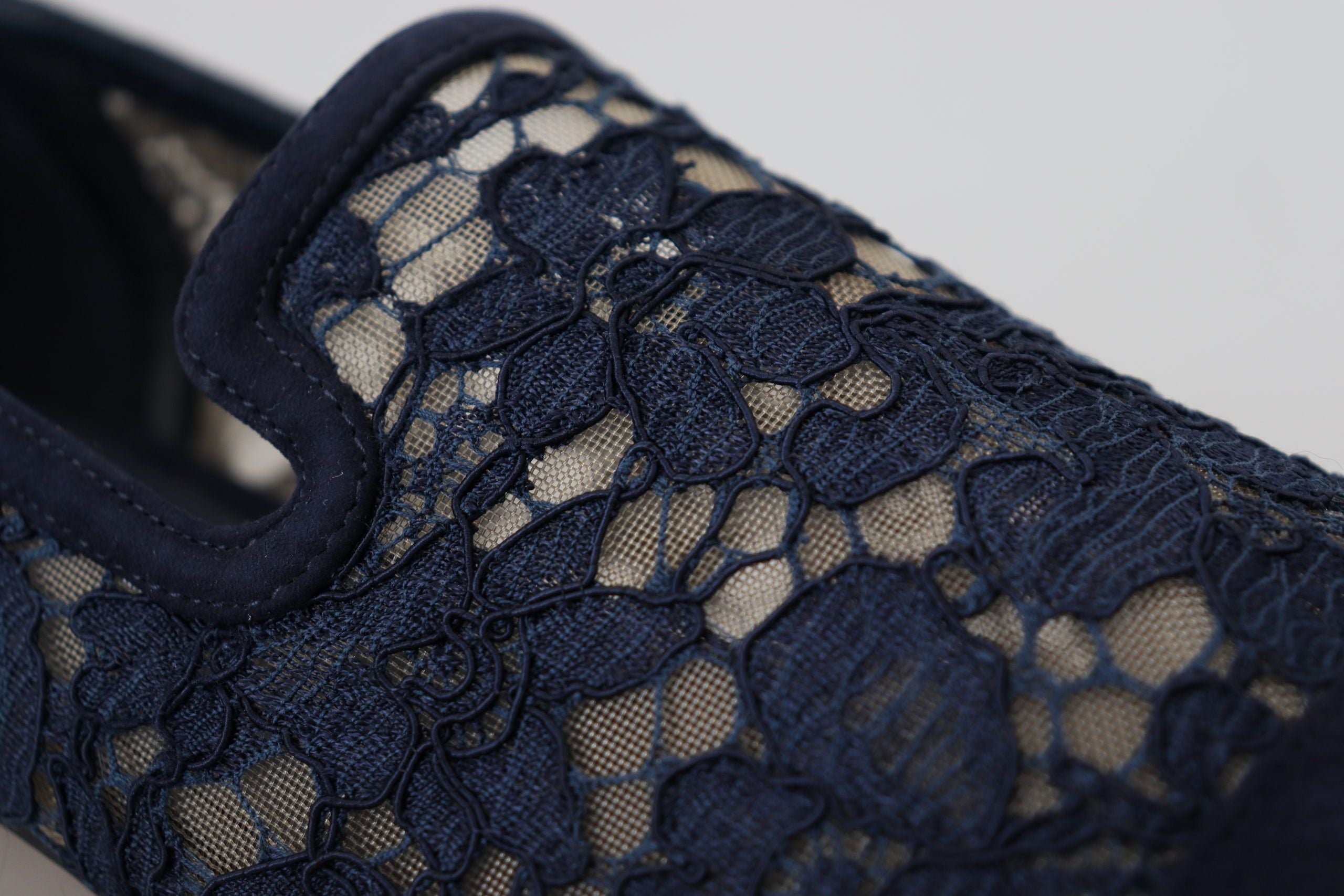 Blue floral lace slip-on loafers by Dolce & Gabbana featuring intricate lace detail and comfortable flat shoe design.