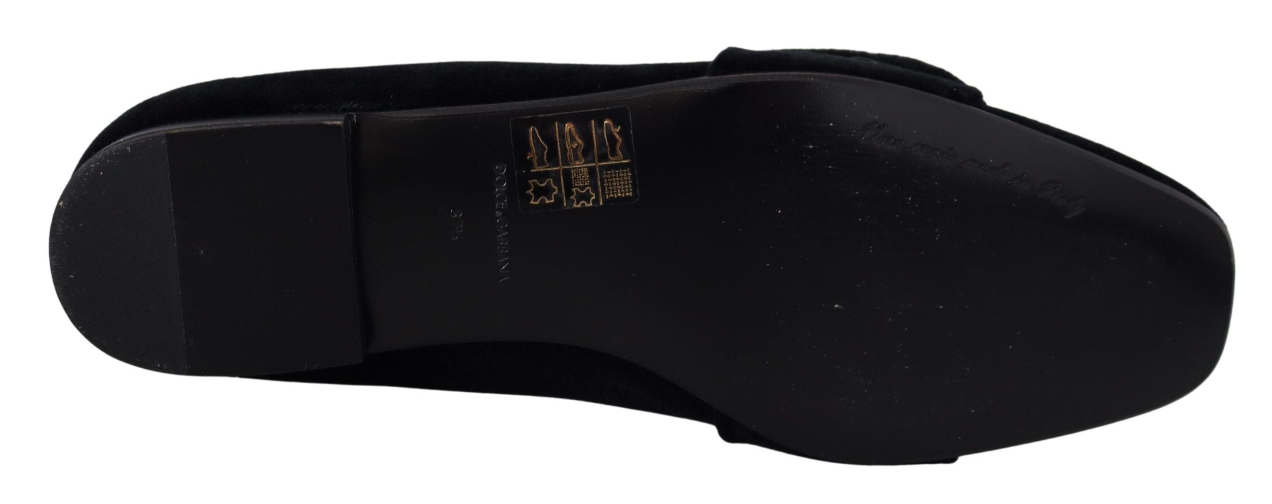Black velvet loafers with crystal embellishments by Dolce & Gabbana, featuring a sleek slip-on design and elegant detailing.