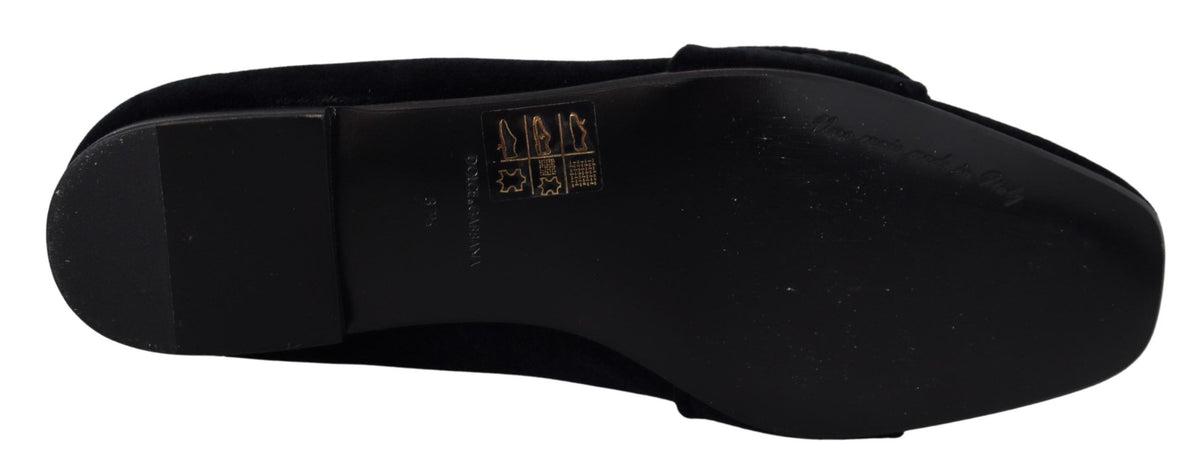 Black velvet loafers with crystal embellishments by Dolce & Gabbana, featuring a sleek slip-on design and elegant detailing.