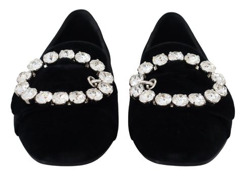 Black velvet loafers with crystal embellishments from Dolce & Gabbana, featuring a sleek slip-on design and elegant detailing.