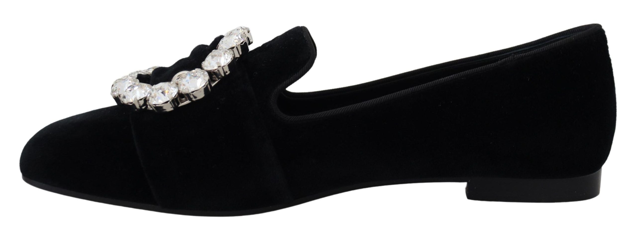 Black velvet loafers with crystal embellishments by Dolce & Gabbana, featuring a sleek flat shoe design.