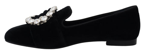 Black velvet loafers with crystal embellishments by Dolce & Gabbana, featuring a sleek flat shoe design.