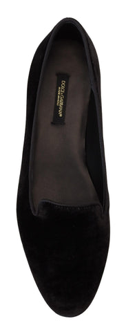 Black velvet Dolce & Gabbana slip-on loafers with sleek flat design and pointed toes, perfect for elegant casual wear.