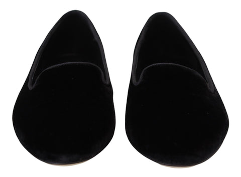 Black velvet slip-on loafers by Dolce & Gabbana, stylish flats shoes with a sleek, smooth finish and classic design.