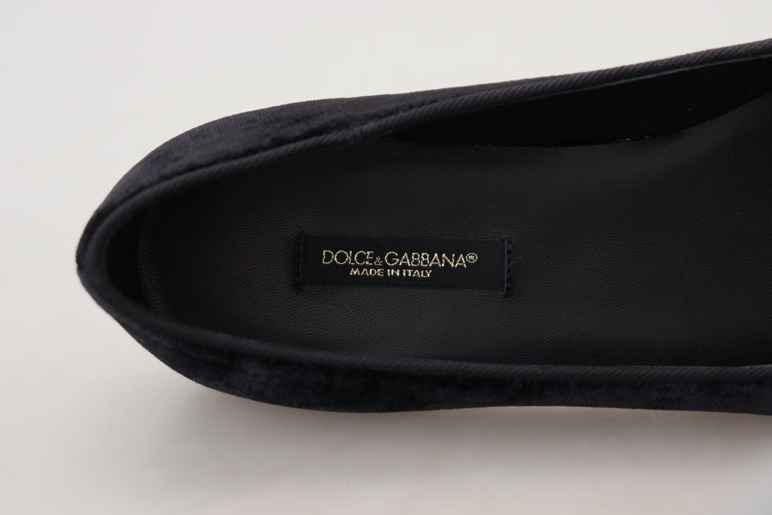 Black velvet slip-on loafers by Dolce & Gabbana, stylish flats with sleek design and smooth texture.
