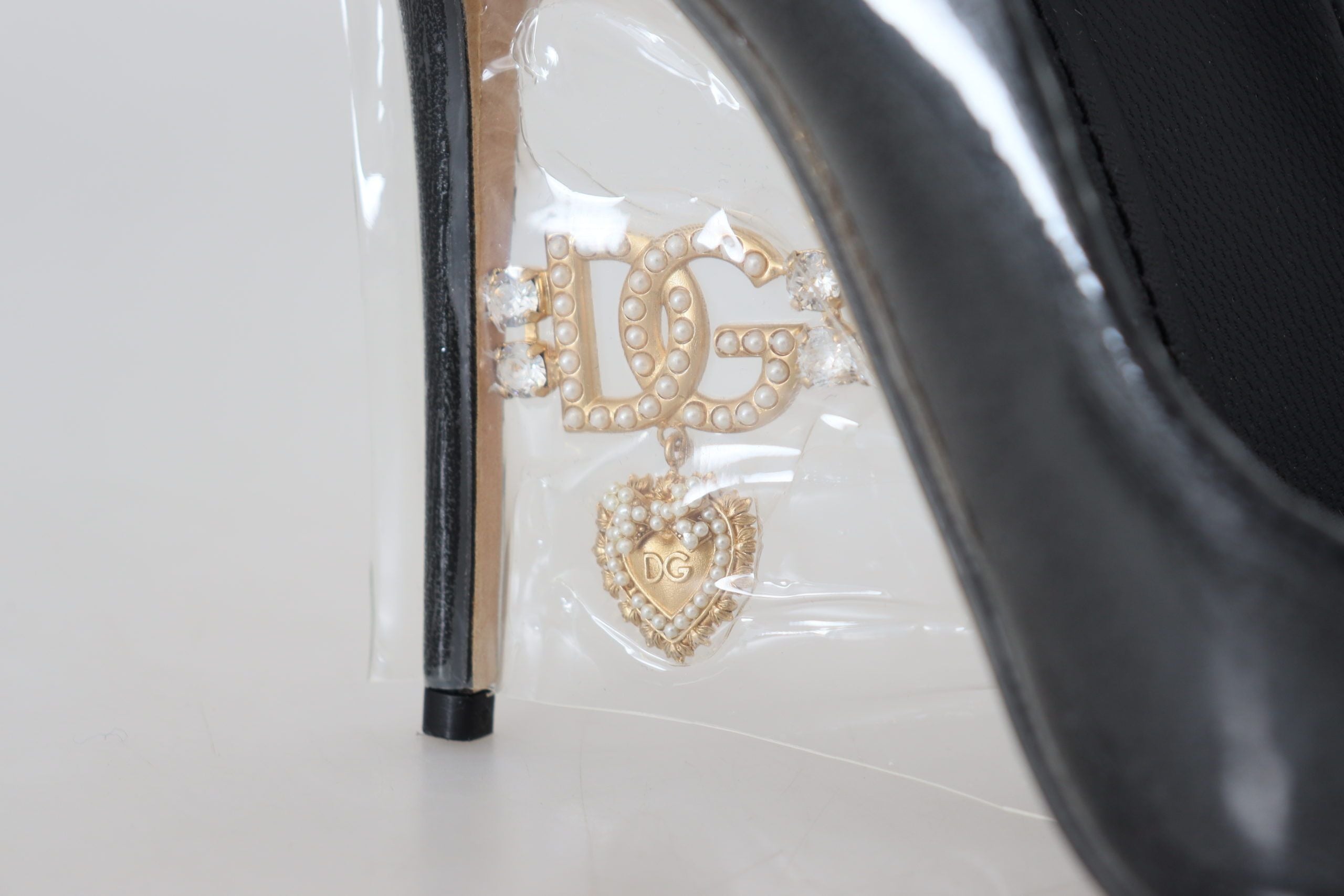 Dolce & Gabbana black leather heel pumps with plastic wrapping, stylish women's high-heeled shoes.