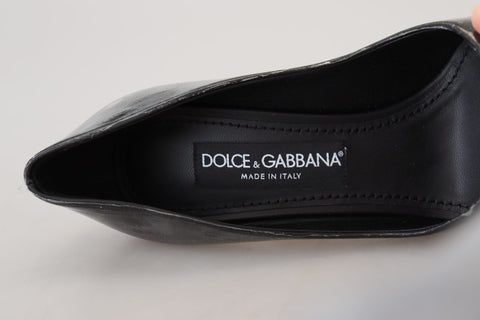Black leather heel pumps by Dolce & Gabbana with plastic wrapped soles, featuring sleek pointed toes and classic elegant design.