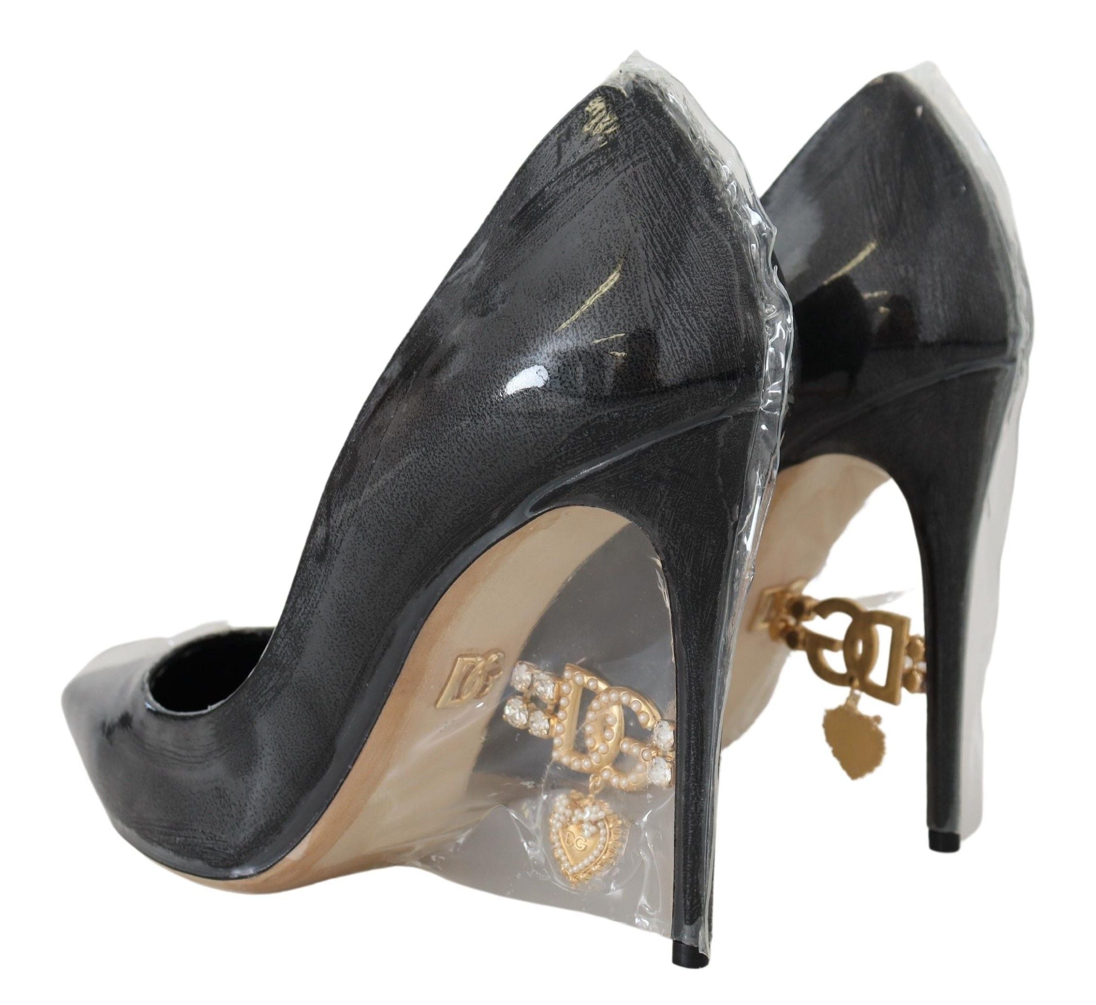 Dolce & Gabbana black leather heel pumps with plastic wrapping, stylish women's footwear on a neutral background.