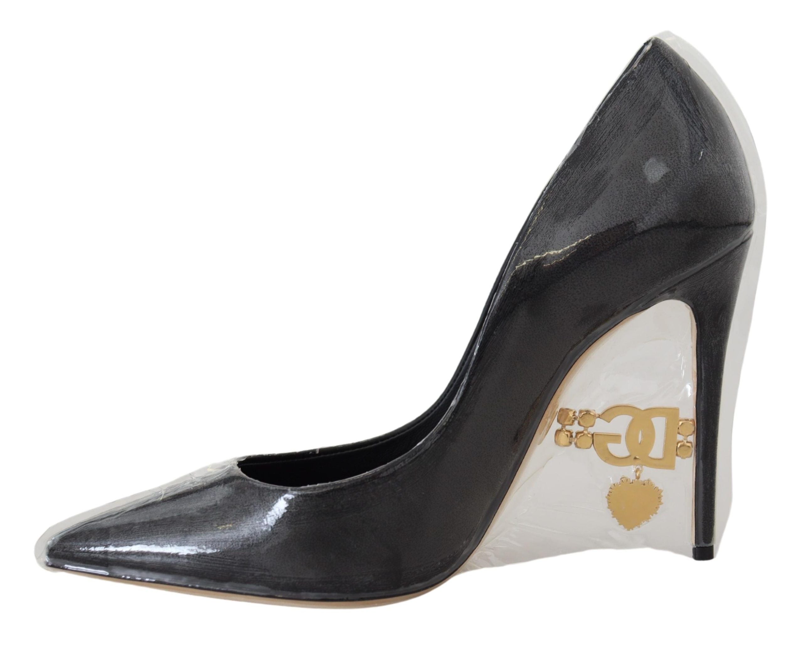 Black leather heel pumps by Dolce & Gabbana with plastic wrapping, showcasing elegant pointed-toe design and sleek silhouette.