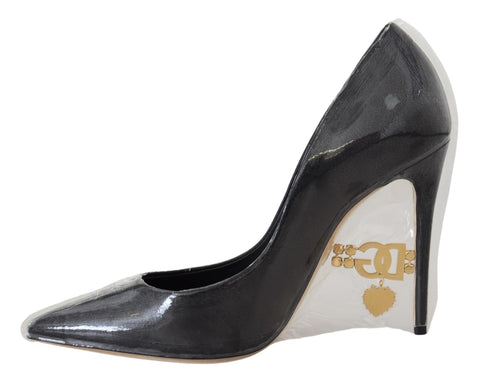 Black leather heel pumps by Dolce & Gabbana with plastic wrapping, showcasing elegant pointed-toe design and sleek silhouette.