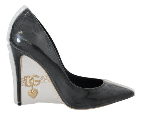 Black leather heel pumps by Dolce & Gabbana with plastic wrapping, showcasing elegant pointed toe design and sleek silhouette.