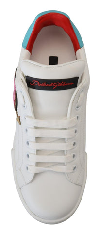 White leather sneaker with Dolce & Gabbana Portofino logo and heart detail, featuring a sleek design and white laces.