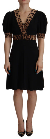 Black leopard print Dolce & Gabbana A-line knee-length dress with long sleeves and fitted waist.
