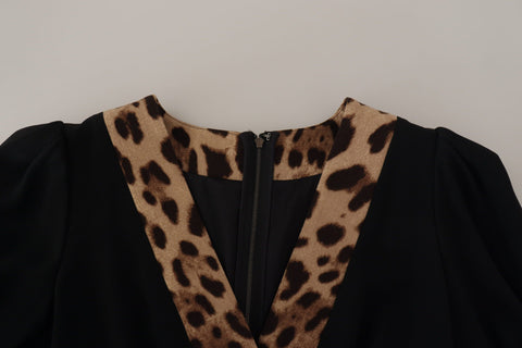 Black leopard print A-line knee-length dress by Dolce & Gabbana, featuring a fitted bodice and flowing skirt.