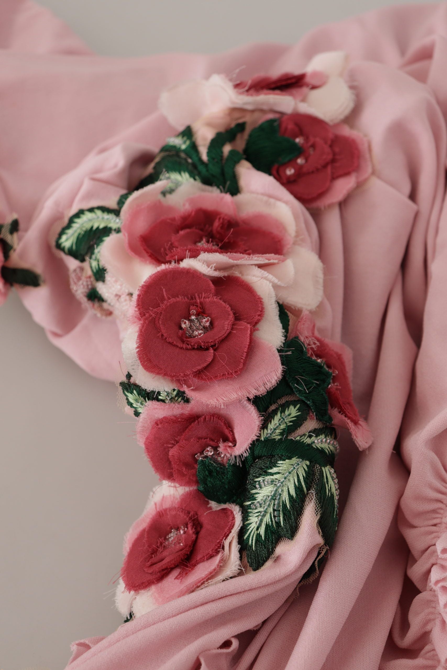 Pink one-shoulder dress with floral embellishments by Dolce & Gabbana, featuring elegant design and intricate flower details.