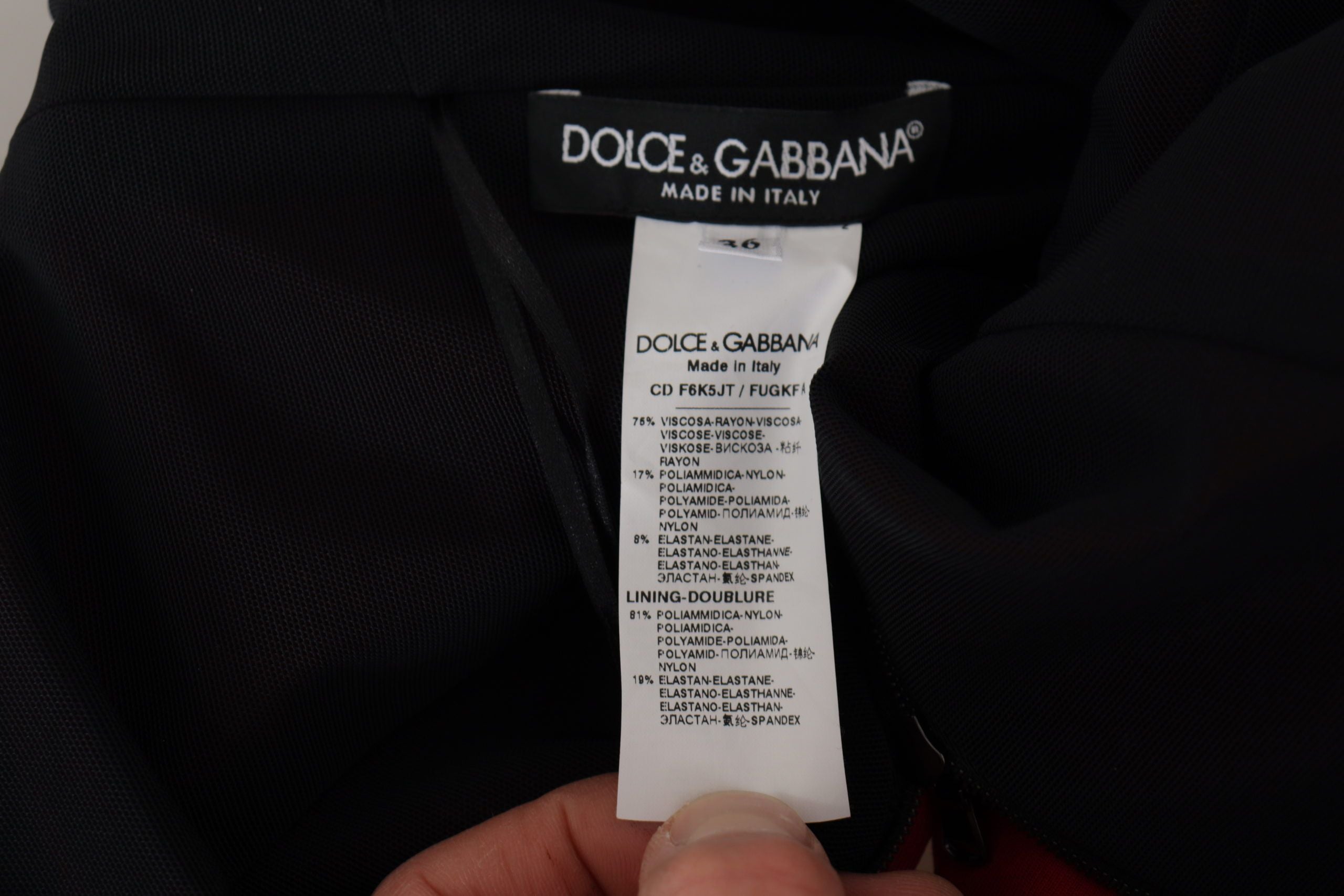Red Dolce & Gabbana sweetheart neck bodycon midi dress displayed on a mannequin, showcasing its fitted silhouette and elegant design.