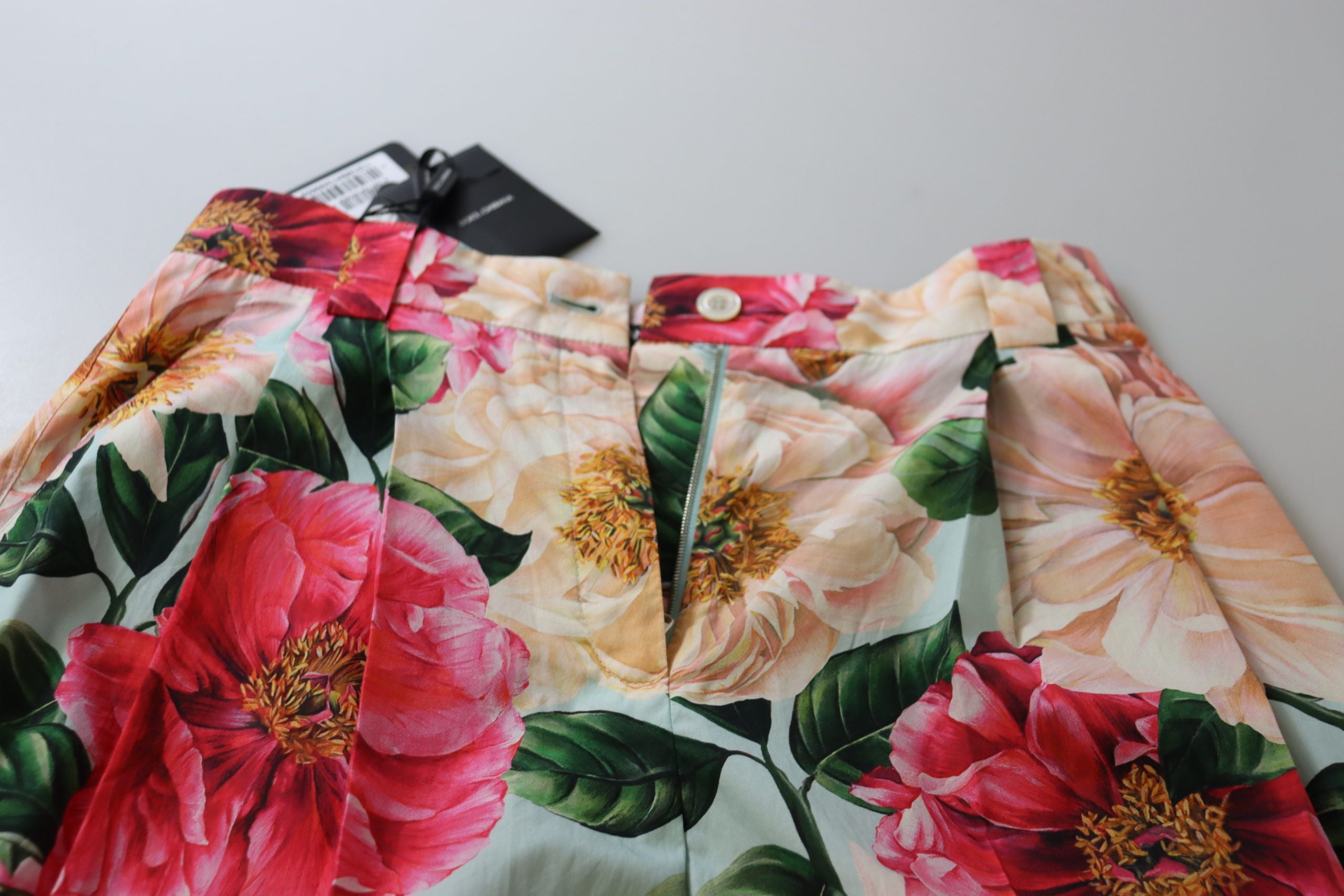 Multicolor flora printed high waist cropped trousers by Dolce & Gabbana, featuring a vibrant floral pattern and tailored fit.