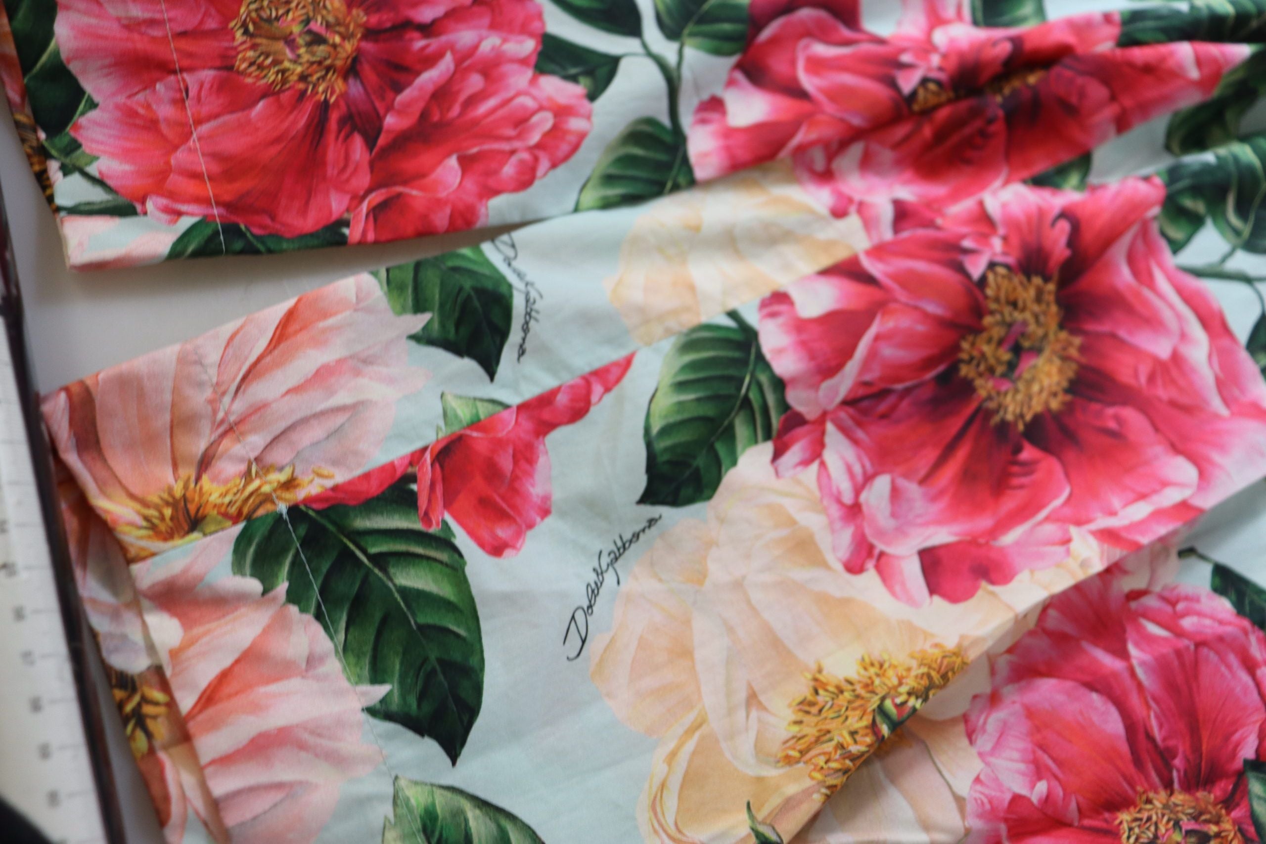 Multicolor floral printed high waist cropped trousers by Dolce & Gabbana, showing vibrant floral pattern and tailored fit.