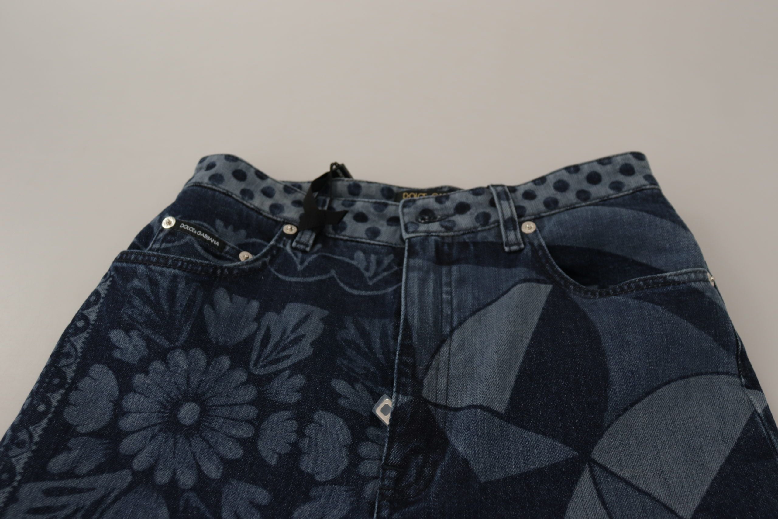 Blue floral high waist skinny denim jeans by Dolce & Gabbana, showing a close-up of the floral pattern and high-rise fit.
