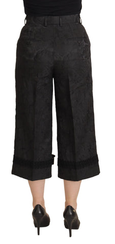 Black brocade cropped high-waist pants by Dolce & Gabbana, featuring intricate fabric details and a tailored fit.