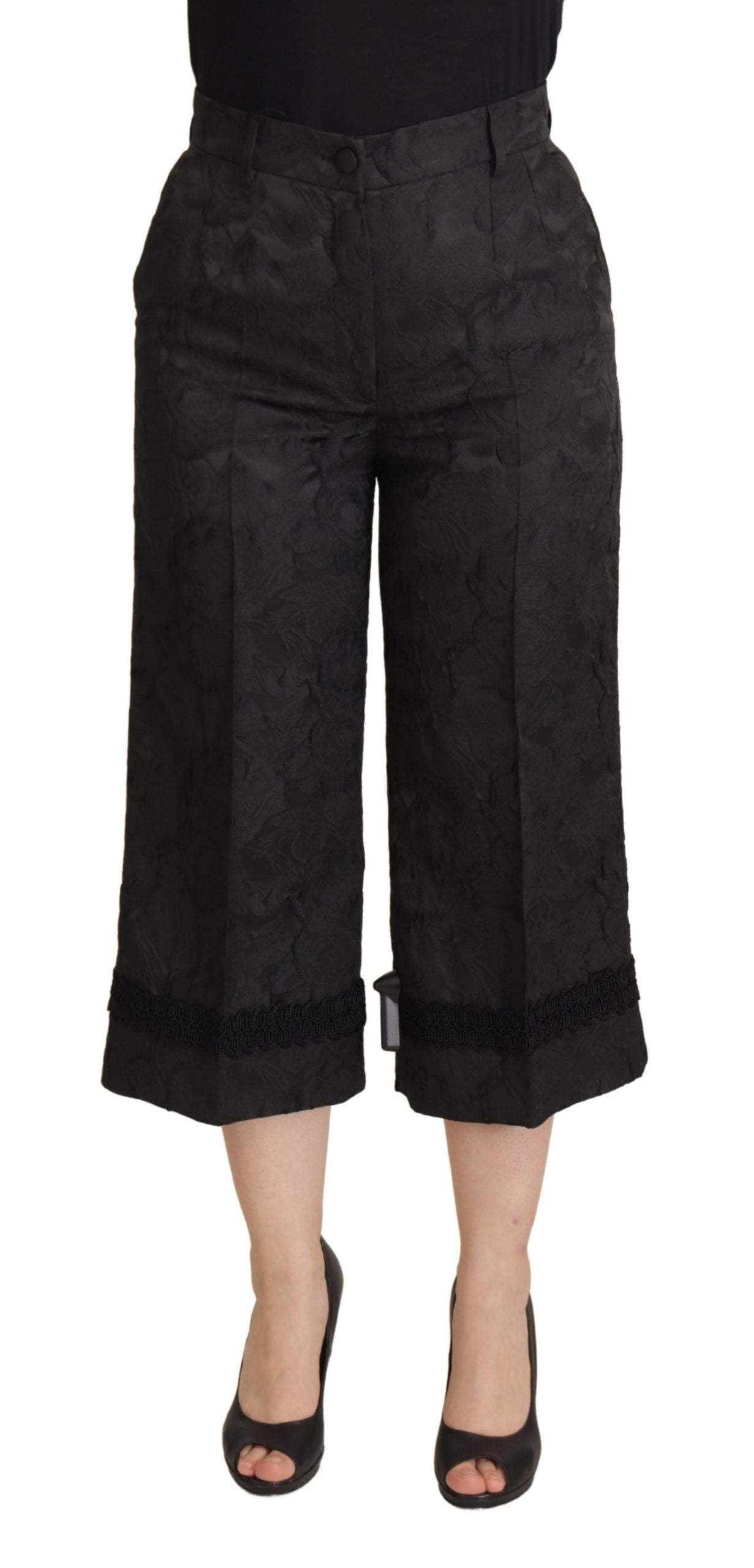 Black brocade cropped high waist pants by Dolce & Gabbana, featuring intricate fabric design and tailored fit.