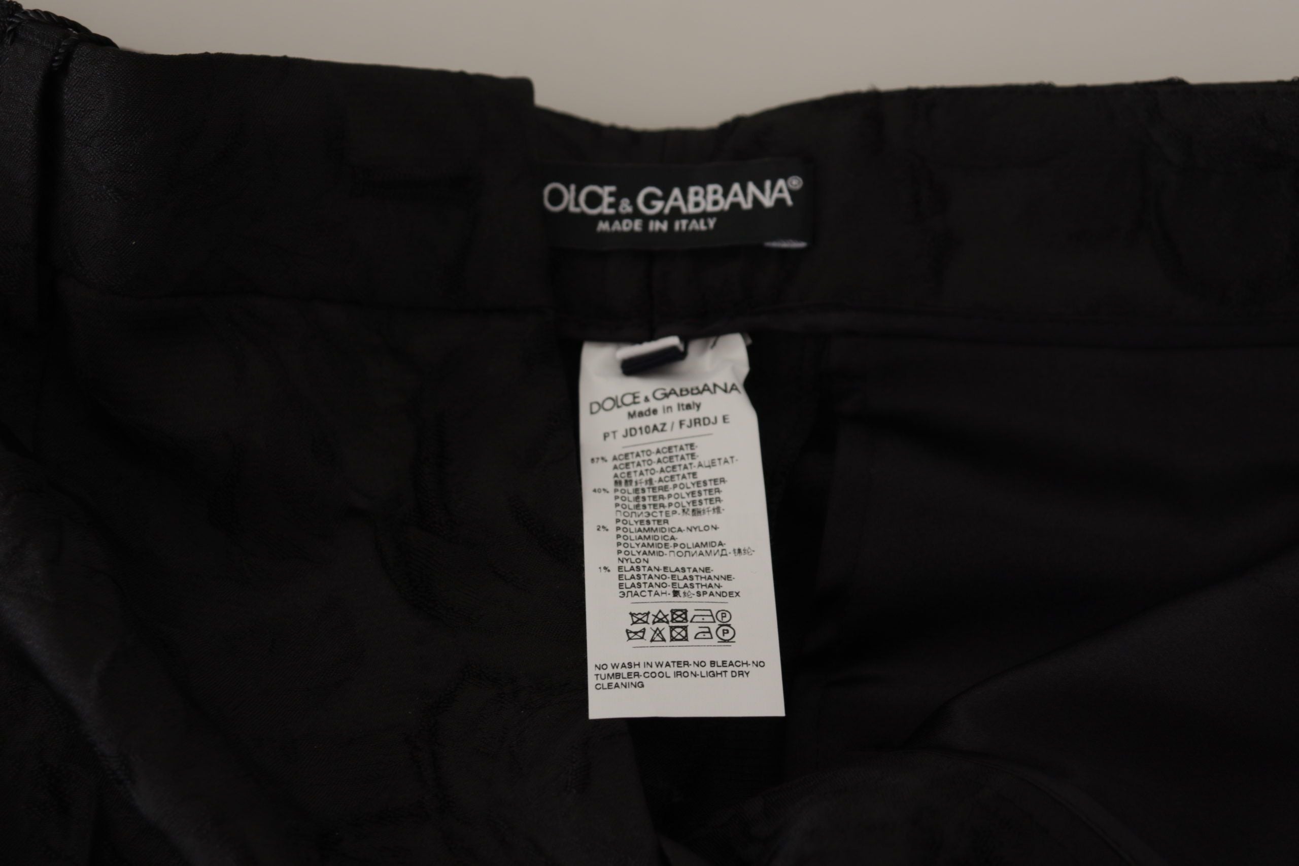 Black brocade cropped high waist pants by Dolce & Gabbana, featuring a luxurious floral pattern and tailored fit.