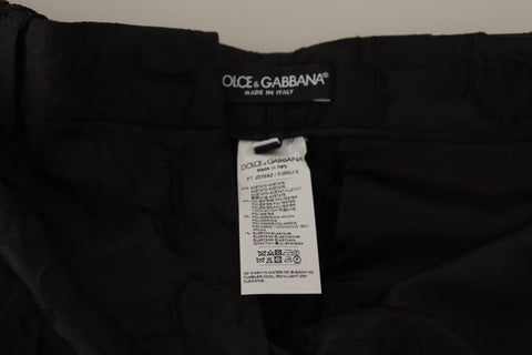 Black brocade cropped high waist pants by Dolce & Gabbana, featuring a luxurious floral pattern and tailored fit.