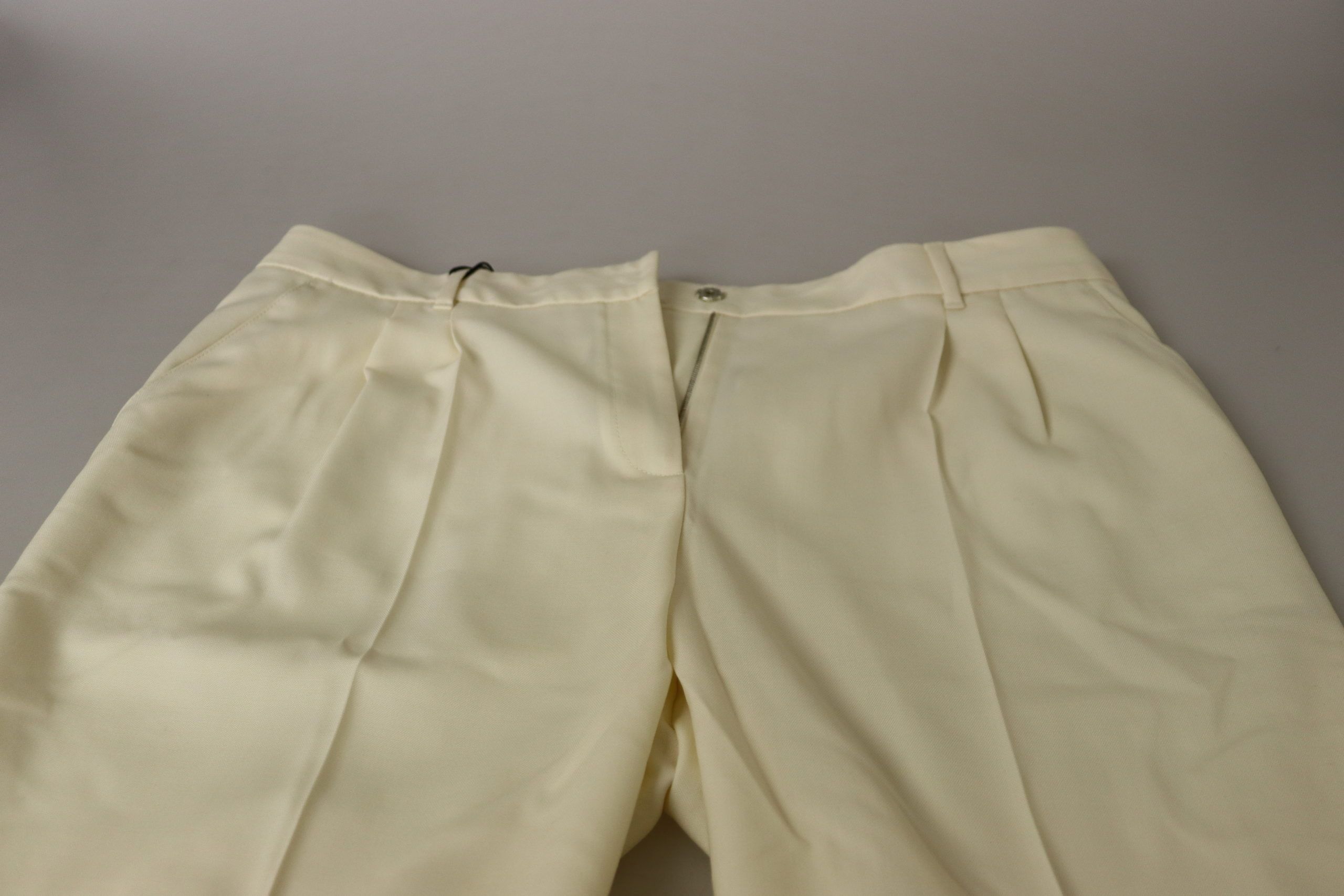 Ivory high-waist cropped trousers with folded hem by Dolce & Gabbana, displayed on a plain background.